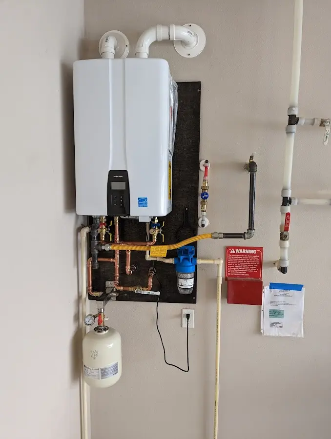 Professional plumber installing copper piping in a Box Elder home